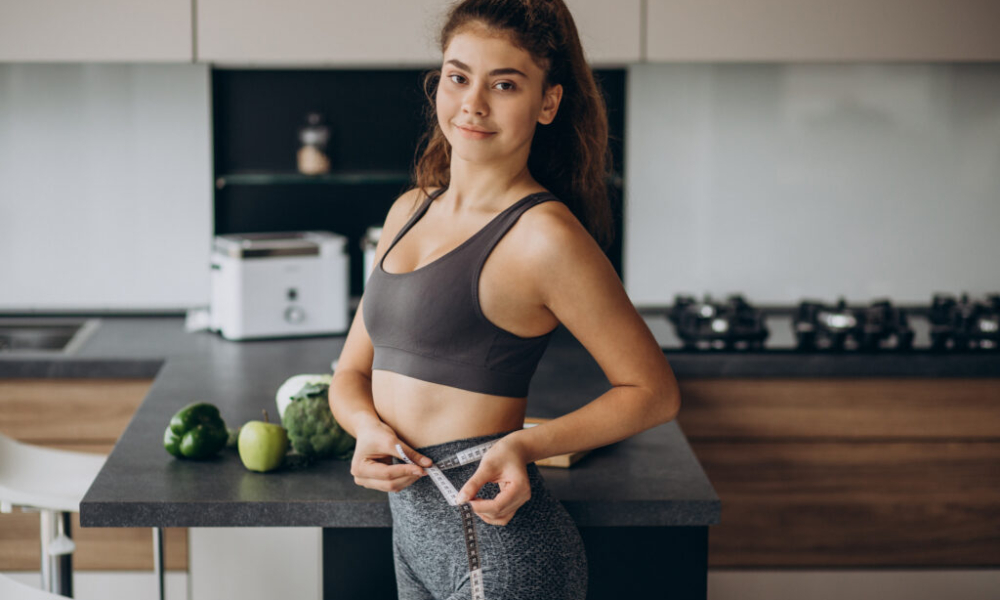 young woman with measuting tape weist kitchen 1024x683 1