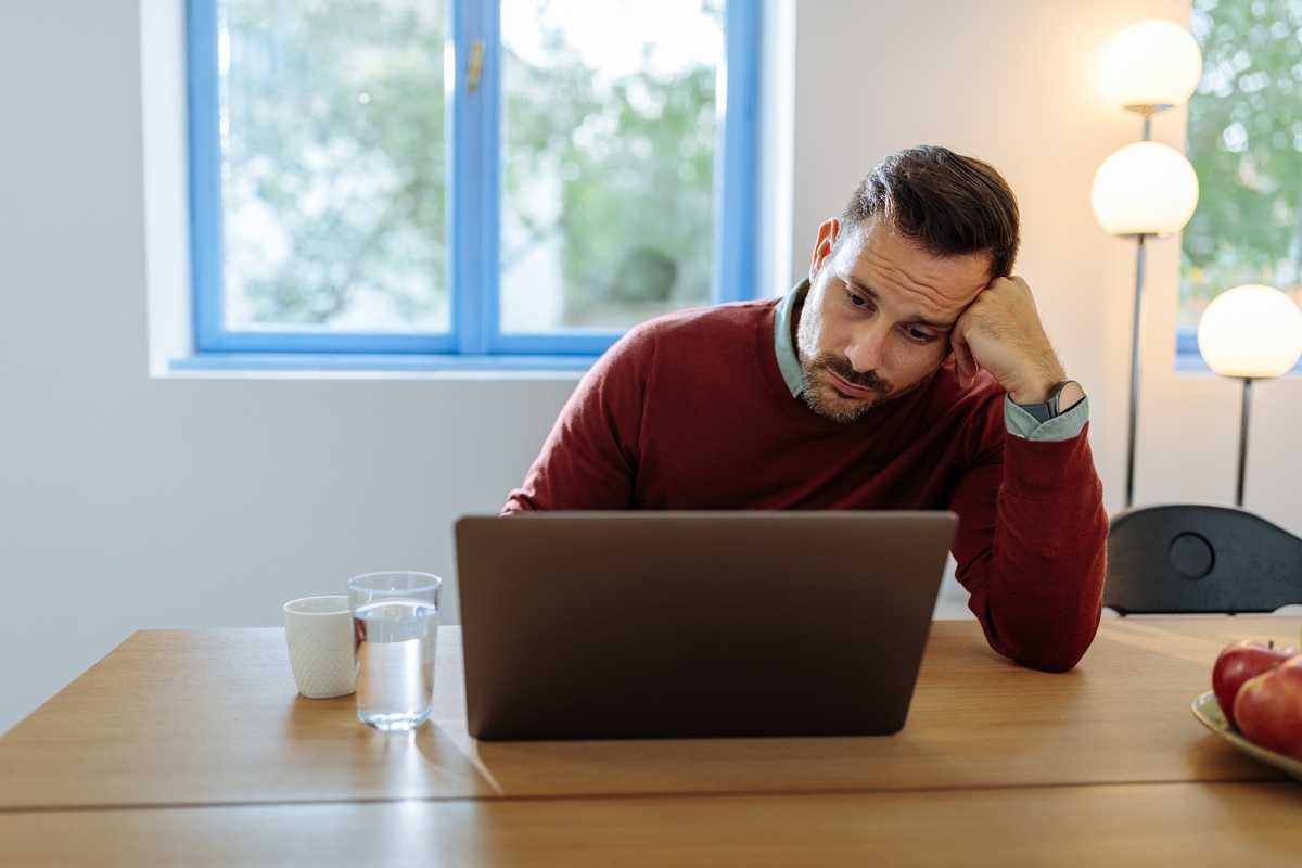 Man looking stressed and overwhelmed, illustrating the connection between TRT and stress