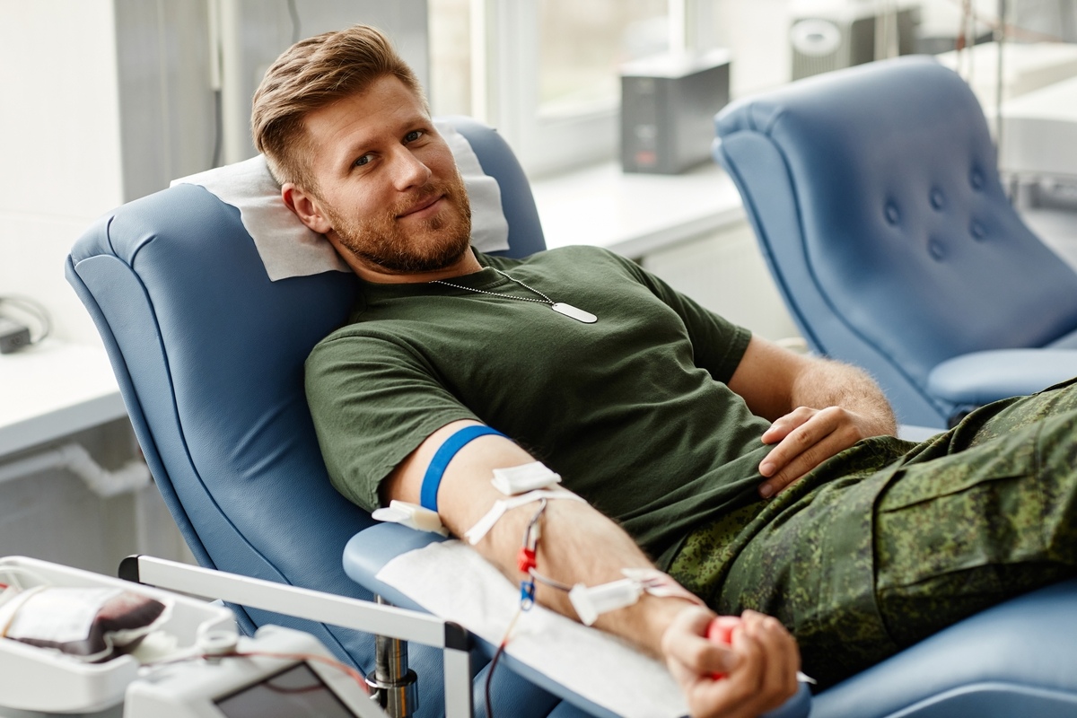 Man comfortably donating blood, illustrating that most men can donate blood on TRT